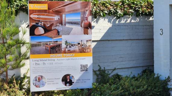 Auction signboard of Acquire Real Estate displayed.