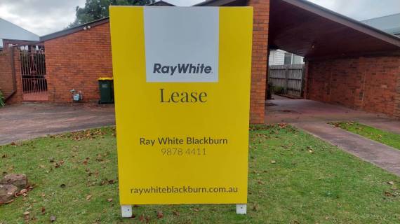 Ray White real estate lease sign displayed in front of a property.