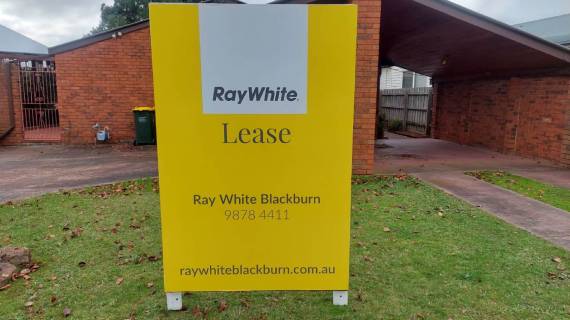 Ray White real estate lease sign displayed in front of a property.