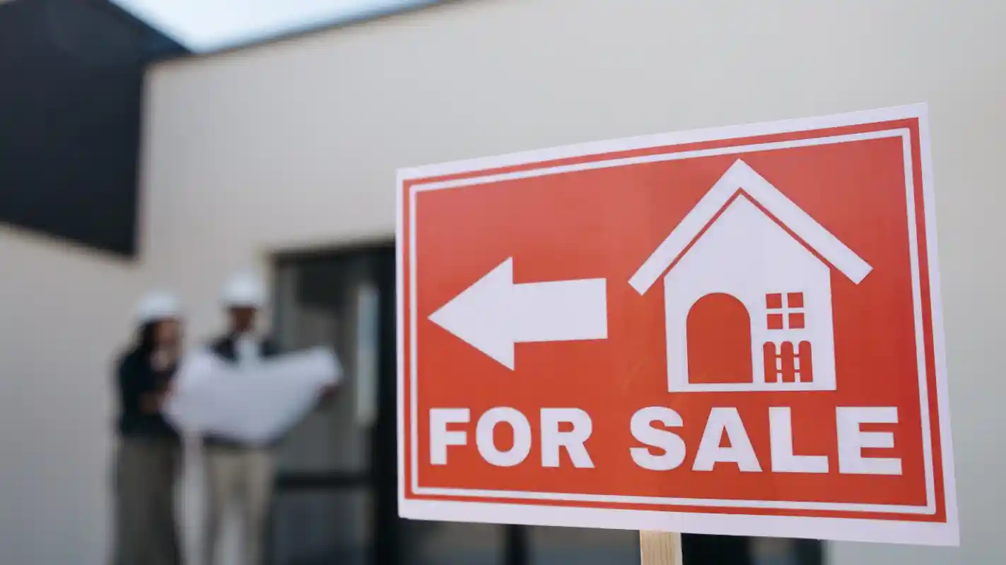 Home for sale directional signboard placed in front of the property